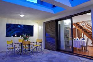 A television and/or entertainment centre at Villa Erato - Your Dream Getaway in Sani Seaside