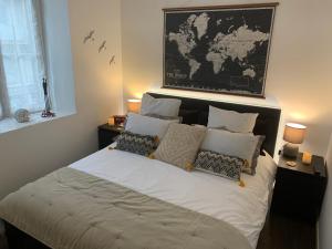 a bedroom with a bed with a map on the wall at Le Servannais in Saint Malo