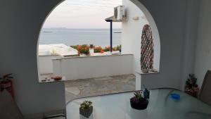 a room with a table and a view of the ocean at Galazio Kyma in Agios Ioannis