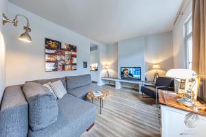 a living room with a couch and a tv at BS Luxury Suites in Heidelberg