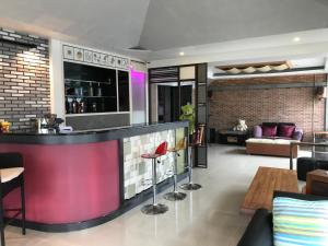 an open living room with a bar in a house at Cafe'@luv22 in Phuket Town