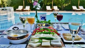 a table with a tray of food and glasses of wine at Renka Hotel & Spa in Göcek