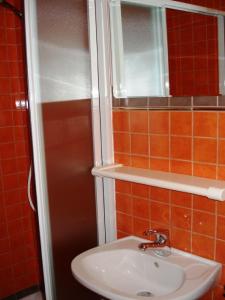 a bathroom with a sink and a mirror at Apartments Percan 448 in Krnica