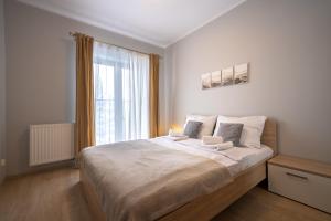 Posteľ alebo postele v izbe v ubytovaní RentPlanet - Apartamenty Górna Resorts