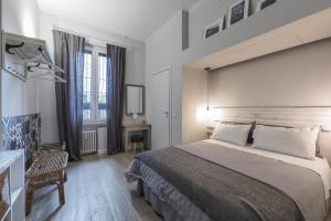 a hotel room with a large bed and a fireplace at Tiaré Home Milano in Milan