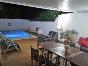 un patio con una mesa y una piscina en LEIDA - Relax y privacidad, en Cala Blanca