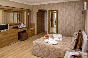 a hotel room with a bed with towels on it at LAUR HOTELS Experience & Elegance in Didim