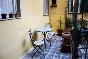 a patio with two tables and chairs on a patio at Casa Ghibellina - city center with outdoor space! in Florence