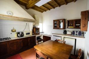 a kitchen with a wooden table in a kitchen at Casa Ghibellina - city center with outdoor space! in Florence