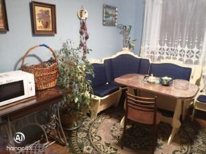 a living room with a table and a blue couch at Aghrougolok Hostel in Lida