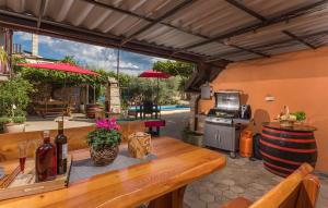 an outdoor patio with a table and a grill at Apartments Ana Vodnjan in Vodnjan