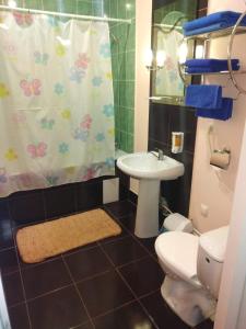 a bathroom with a sink and a toilet and a shower at Отель Ритм in Vinnytsya
