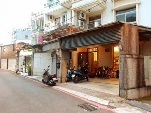a couple of motorcycles parked outside of a building at 7-1 House Homsetay in Hualien City