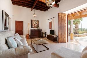 a living room with a couch and a table at Villa Sa Cuina in Sant Rafael de Sa Creu