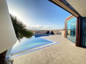 a swimming pool with a view of a house at VILLA LOBA WITH PRIVATE POOL in Costa Calma