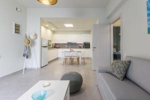 a living room with a couch and a table at Seashell Apt 2 in Stalida