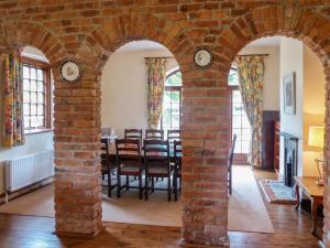 a brick archway in a room with a dining room at The Coach House in Piltown