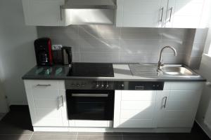 a kitchen with a sink and a stove top oven at Villa Luise in Hameln