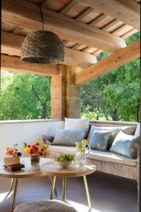 a living room with a couch under a wooden ceiling at Mas Generós - Adults-Only Eco Hotel in Fonteta