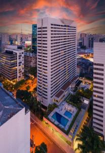 an aerial view of a large white building in a city at Radisson São Paulo Paulista in Sao Paulo