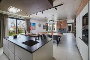 a kitchen and dining room with a large island in a house at Villa Ansi by Villas Holiday in Višnjan