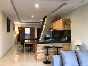 a kitchen and living room with a table and a couch at BUYAN LODGE lake view villa in Bedugul
