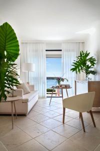 a living room with a view of the ocean at Hotel Don Pepe Gran Meliá in Marbella