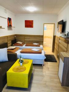 A bed or beds in a room at Melánia Vendégház
