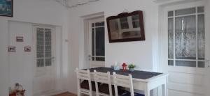 a white room with a table and two chairs at Apartament La poteca ursului in Buşteni +41 photos