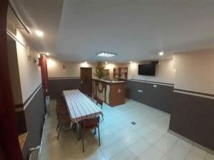 a room with a table and chairs and a tv at Casa Edi in Poiana Negrii