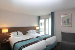 מיטה או מיטות בחדר ב-Holiday Inn Paris Montmartre, an IHG Hotel