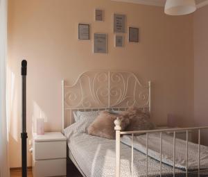 a bedroom with a bed with a gray bed frame at Apartment Orchid 021 in Novi Sad