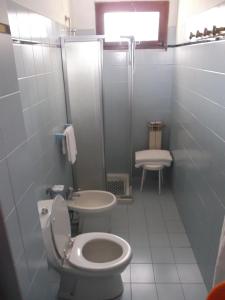 a bathroom with a toilet and a sink and a shower at Albergo Ristorante Gori in Ameglia