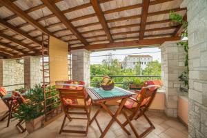 a patio with a table and chairs on a balcony at Apartment Andrea 329 in Vodnjan