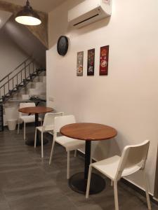 a row of tables and chairs in a restaurant at Just Austin Guesthouse in Ipoh
