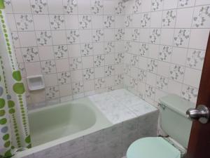a bathroom with a bath tub and a toilet at apartamento CAA pardo in Lima
