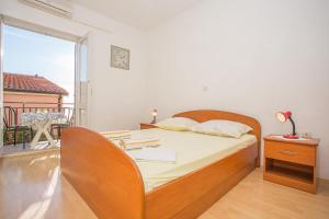 a bedroom with a bed and a large window at Apartments Nuic in Makarska