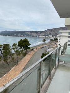 a view of the beach from the balcony of a building at Beach Luxury Apartment Shëngjin in Lezhë