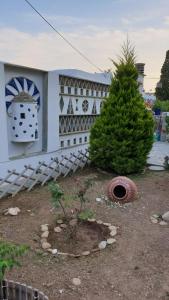 a house with a christmas tree in front of it at Galazio Kyma in Agios Ioannis