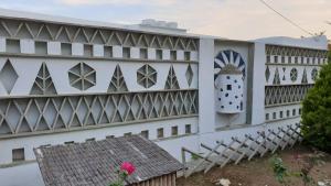 a building with a clock on the side of it at Galazio Kyma in Agios Ioannis
