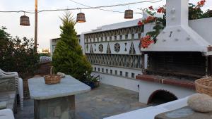 a outdoor patio with a fireplace and a table at Galazio Kyma in Agios Ioannis