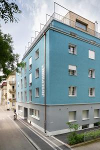 a blue building on the side of a street at Josephine's Guesthouse - ! WOMEN ONLY ! in Zurich