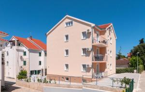 a large apartment building with balconies on a street at Apartments Island Beat in Supetar
