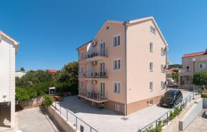 a building with a car parked in front of it at Apartments Island Beat in Supetar +64 photos
