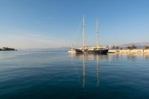 a boat sitting in the middle of the water at Apartments Island Beat in Supetar