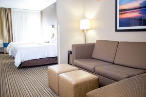 ein Hotelzimmer mit einem Sofa und einem Bett in der Unterkunft Holiday Inn Express & Suites Hayward, an IHG Hotel in Hayward