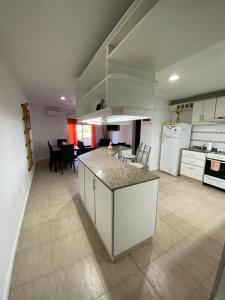 a kitchen and dining room with a island in the middle at RondPoint Pilar in Pilar