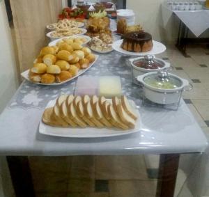 a table with many plates of food on it at Catalao Palace Hotel in Catalão