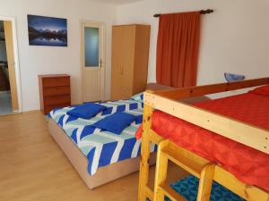 a bedroom with two bunk beds with blue pillows at Apartments Nikol in Lopar