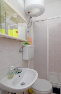 a bathroom with a white sink and a toilet at Rooms&Studios Rina in Dubrovnik